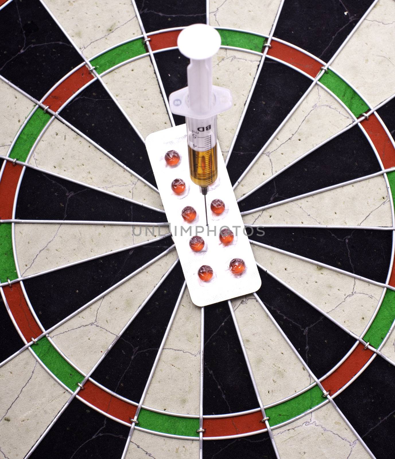 syringe  in target on darts board by gsdonlin
