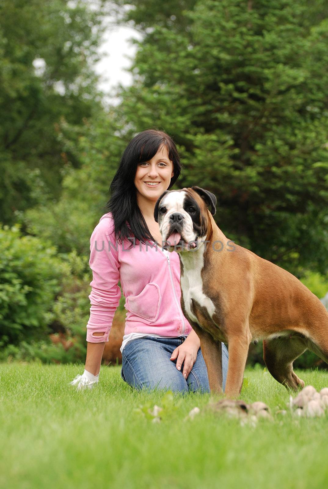 The girl with a dog sit on a grass before them mushrooms grow