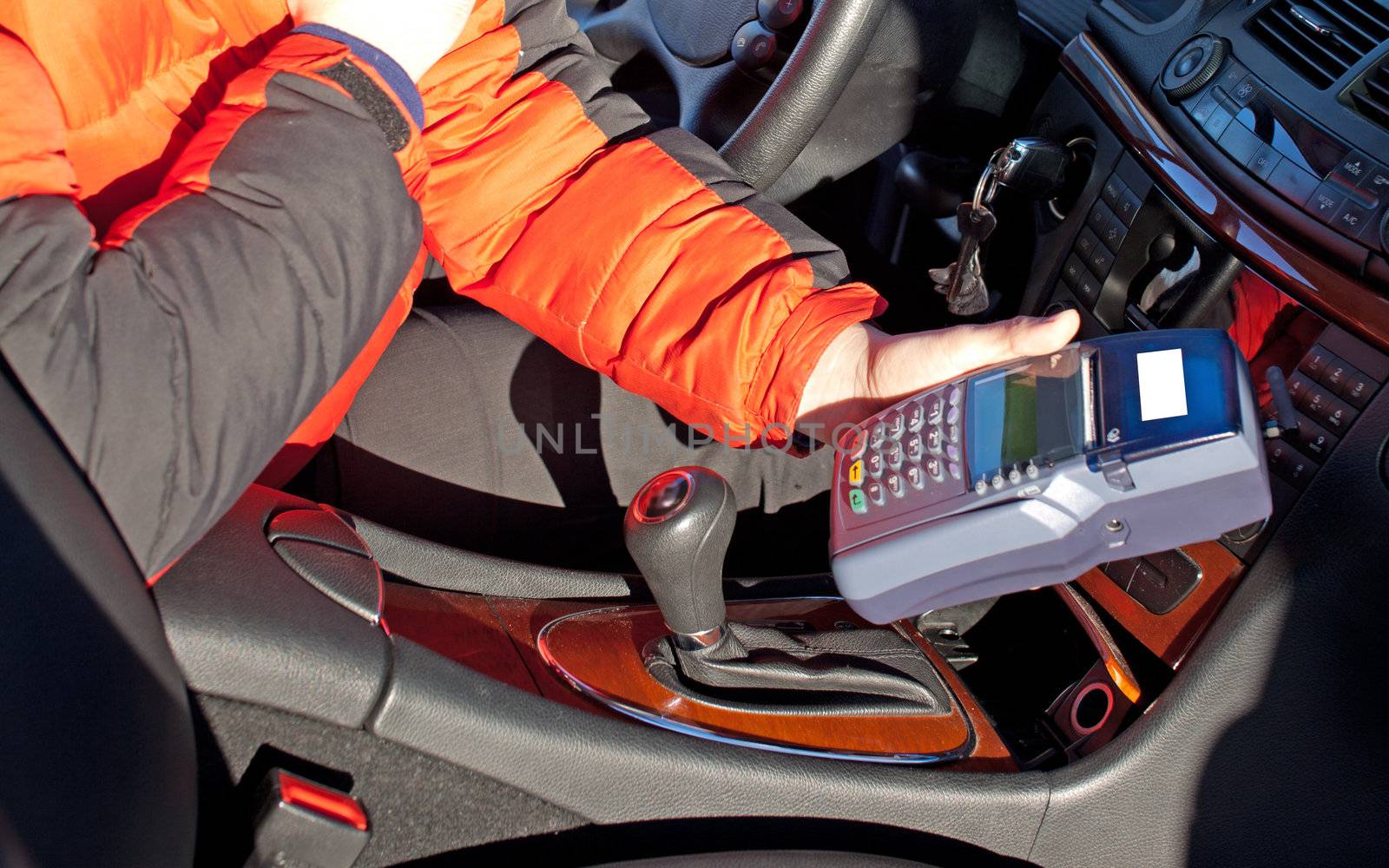 Credit card reader in taxi drivers hand in car