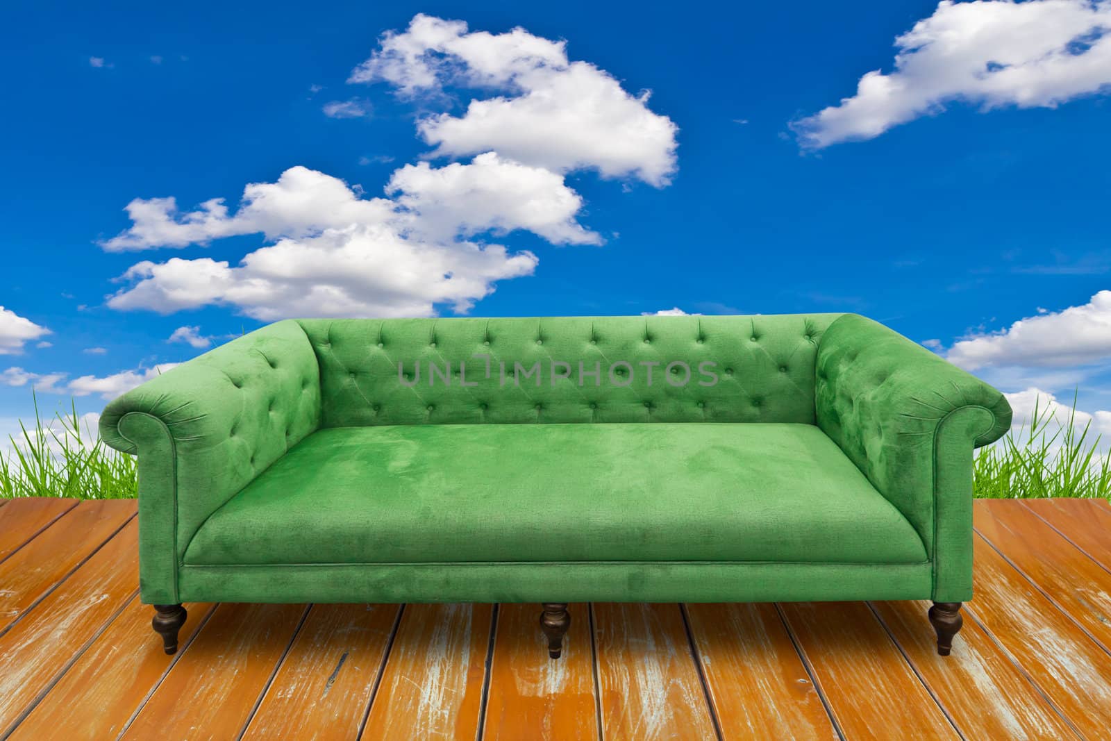 green sofa on wood floor by tungphoto