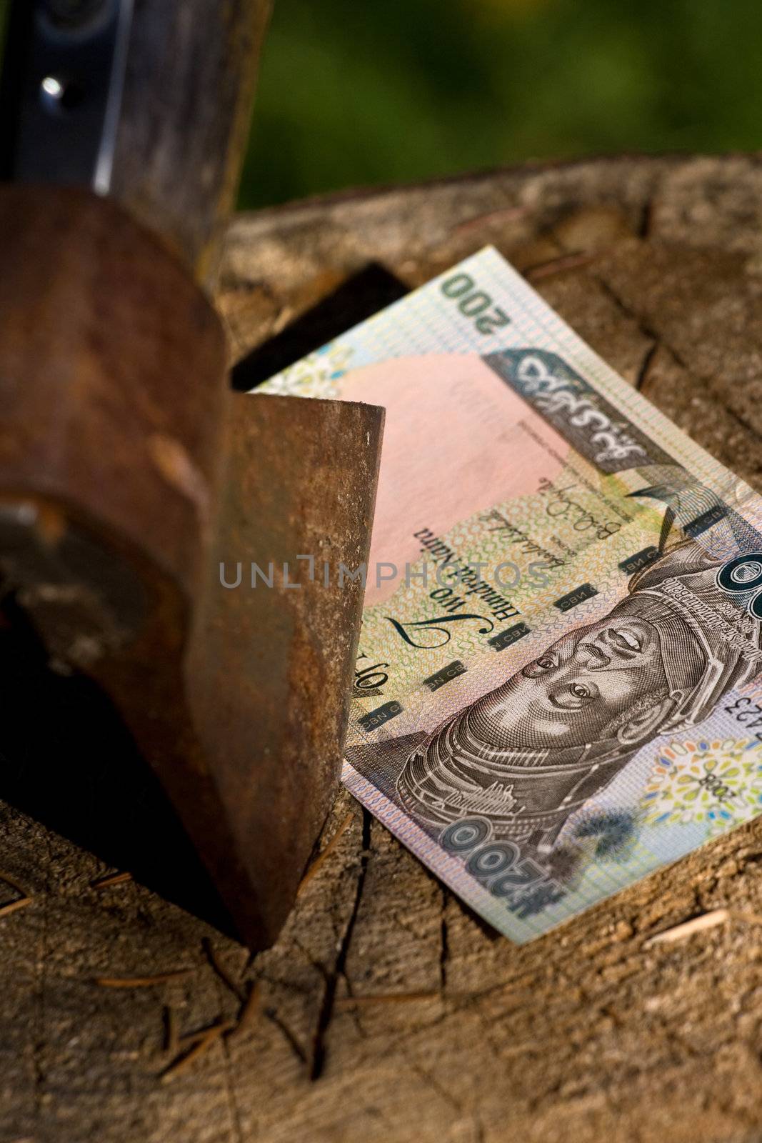 A 200 naira banknote being cut with an axe