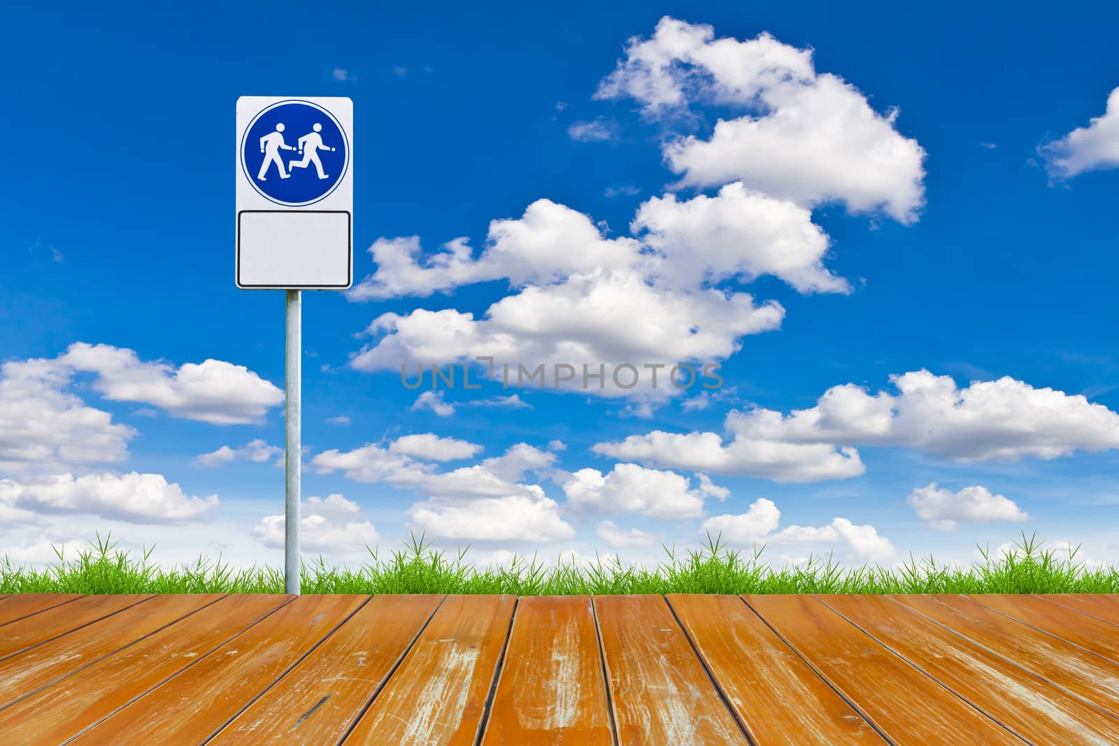 wood walk way and sign against blue sky