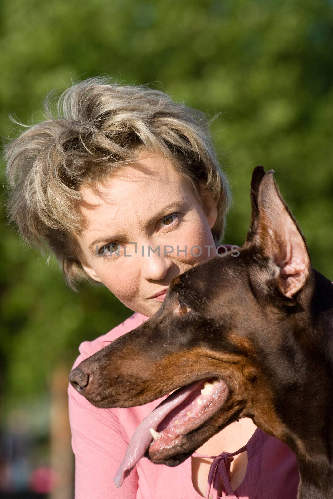 Young woman with old dobermann dog