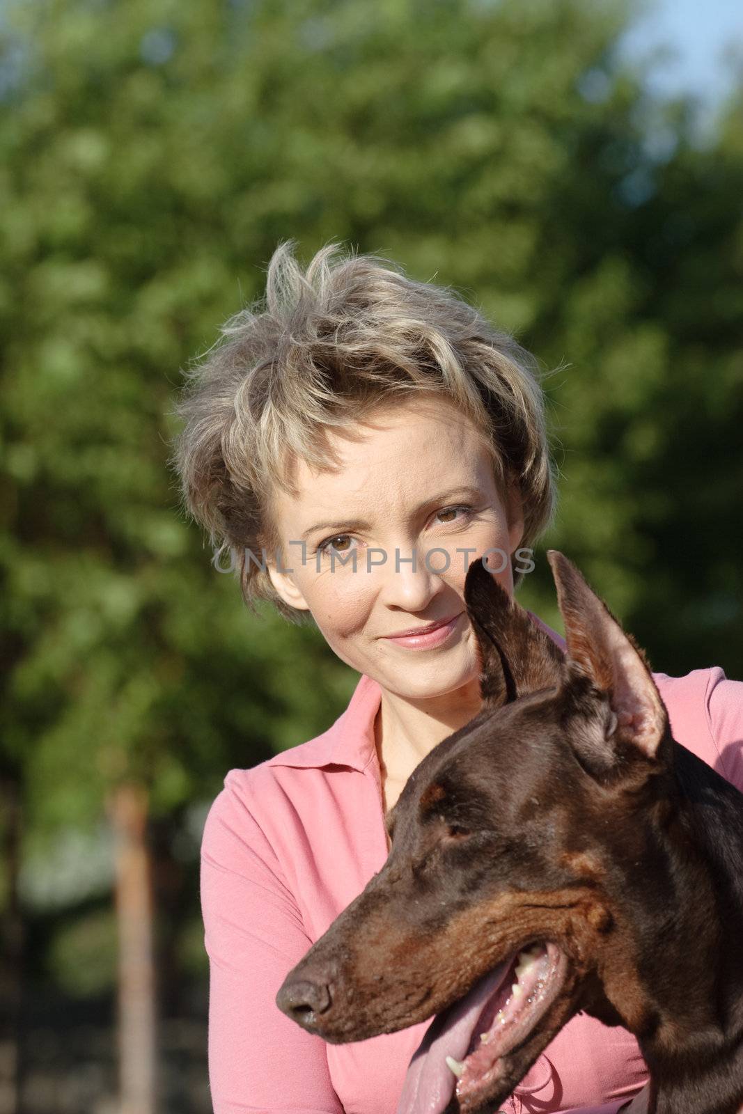 Young woman with old dobermann dog