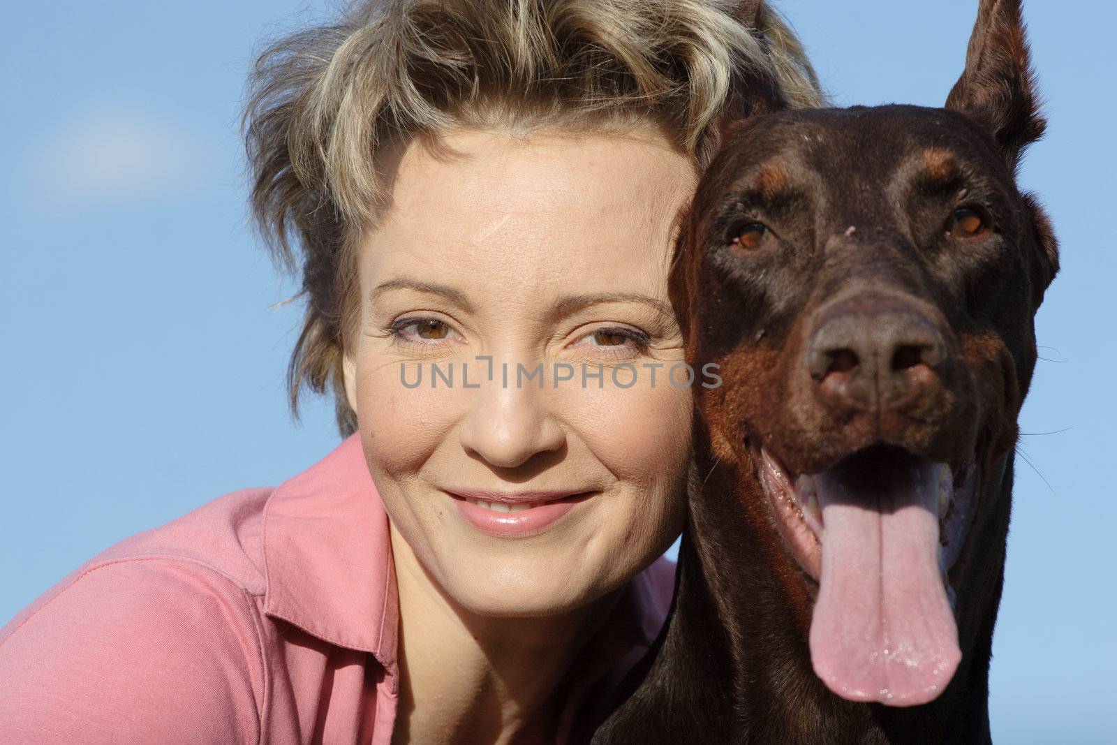 Young woman with old dobermann dog