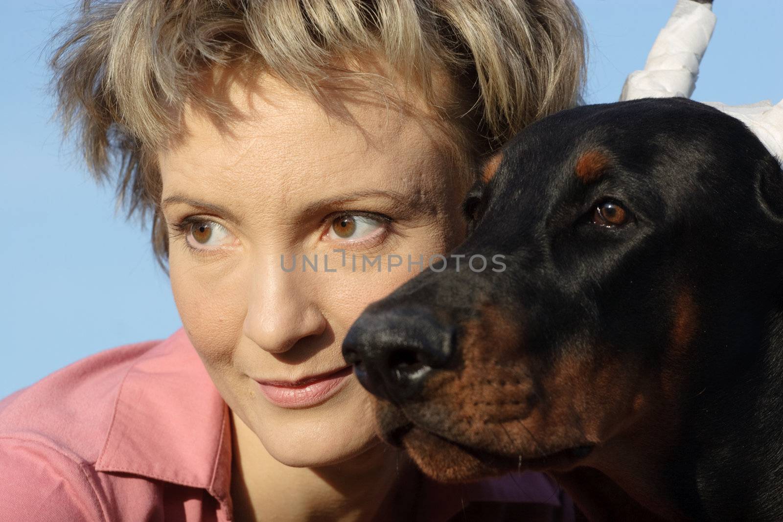 Young woman with old dobermann dog