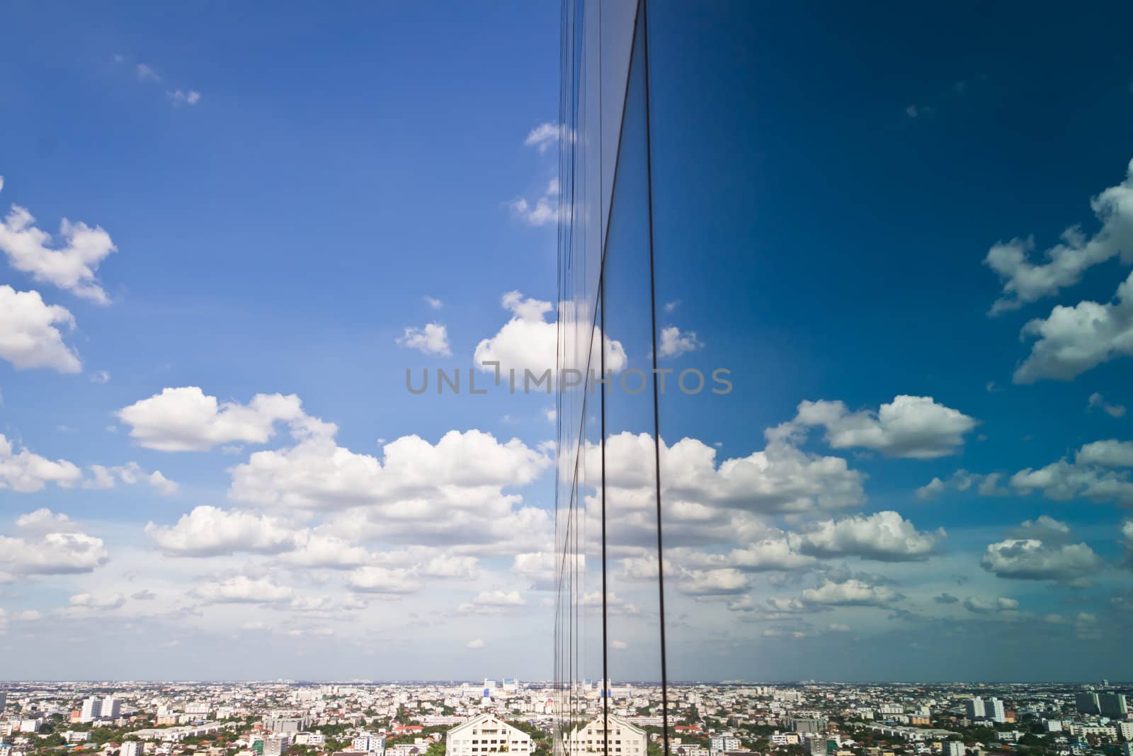 cloud and sky reflection in mirror of building by tungphoto