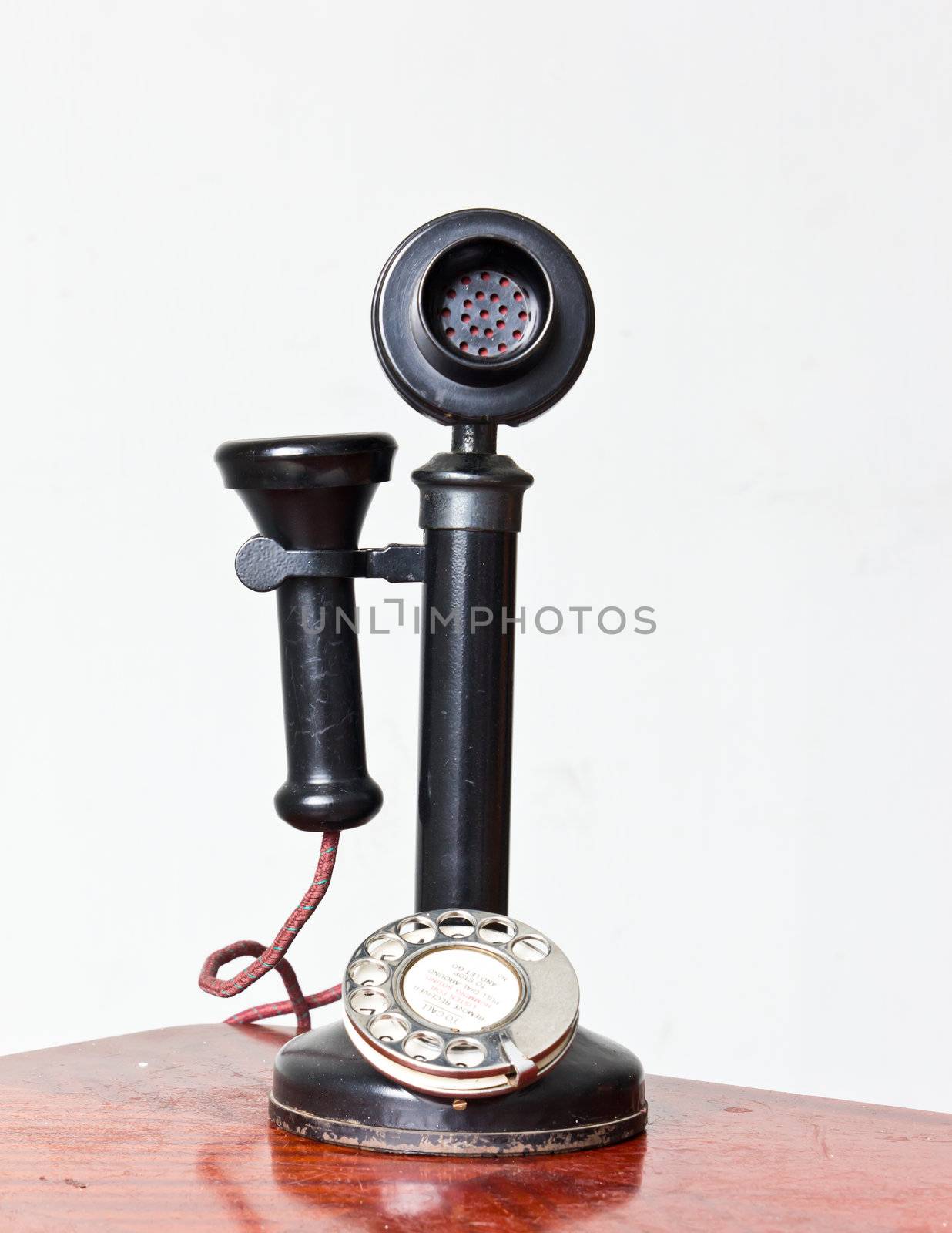 vintage telephone with it reflection isolated by tungphoto