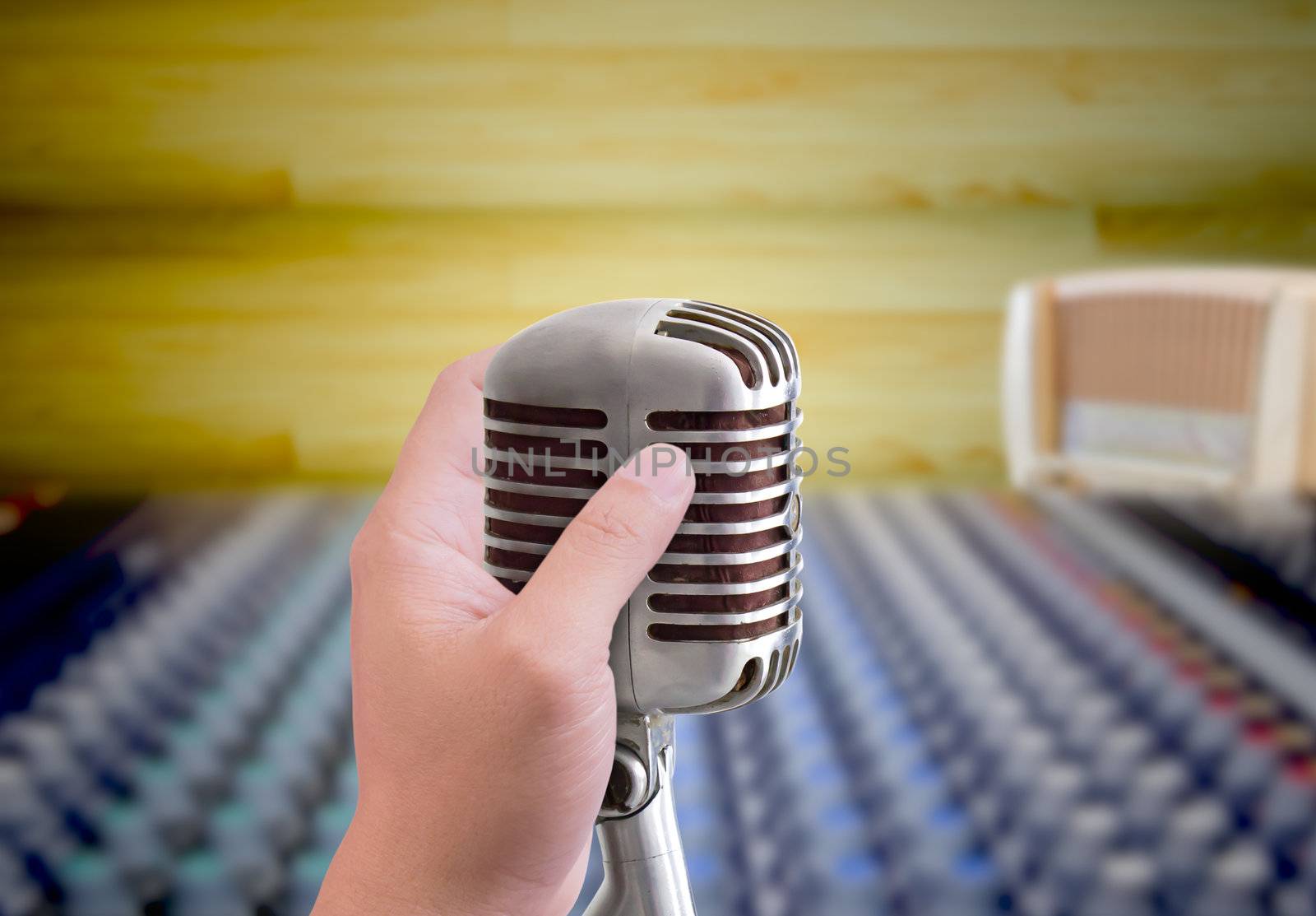 hand holding microphone in sound record room by tungphoto