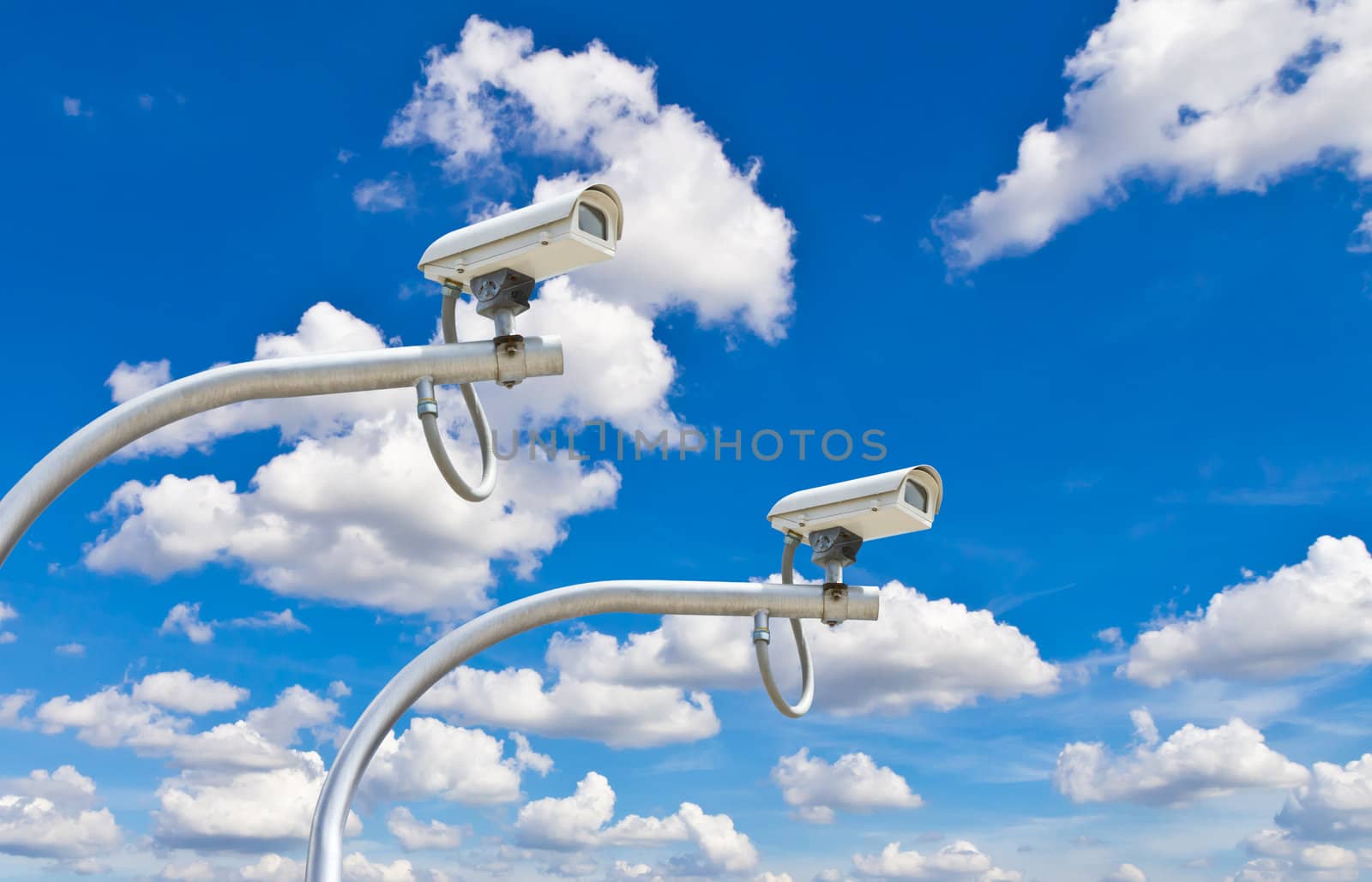 outdoor cctv cameras against blue sky by tungphoto