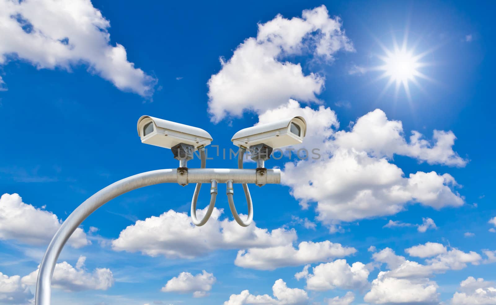outdoor cctv cameras against blue sky and sunshine by tungphoto