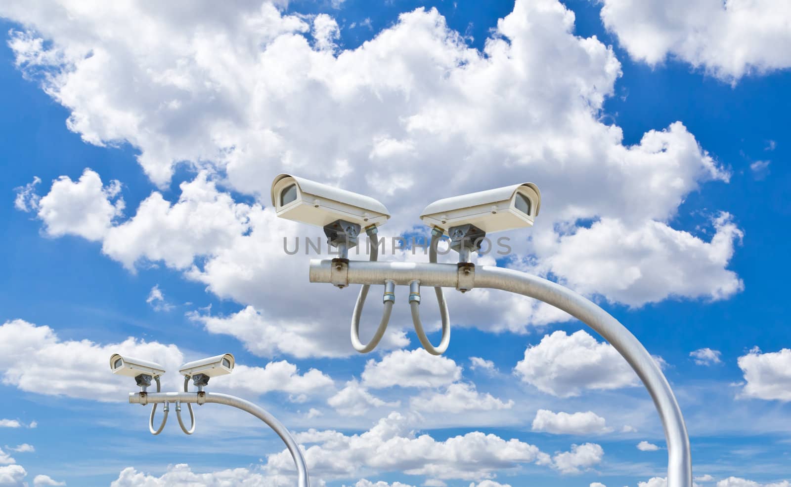 outdoor cctv cameras against blue sky by tungphoto
