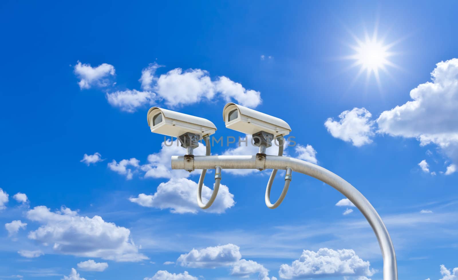 surveillance cameras against blue sky by tungphoto