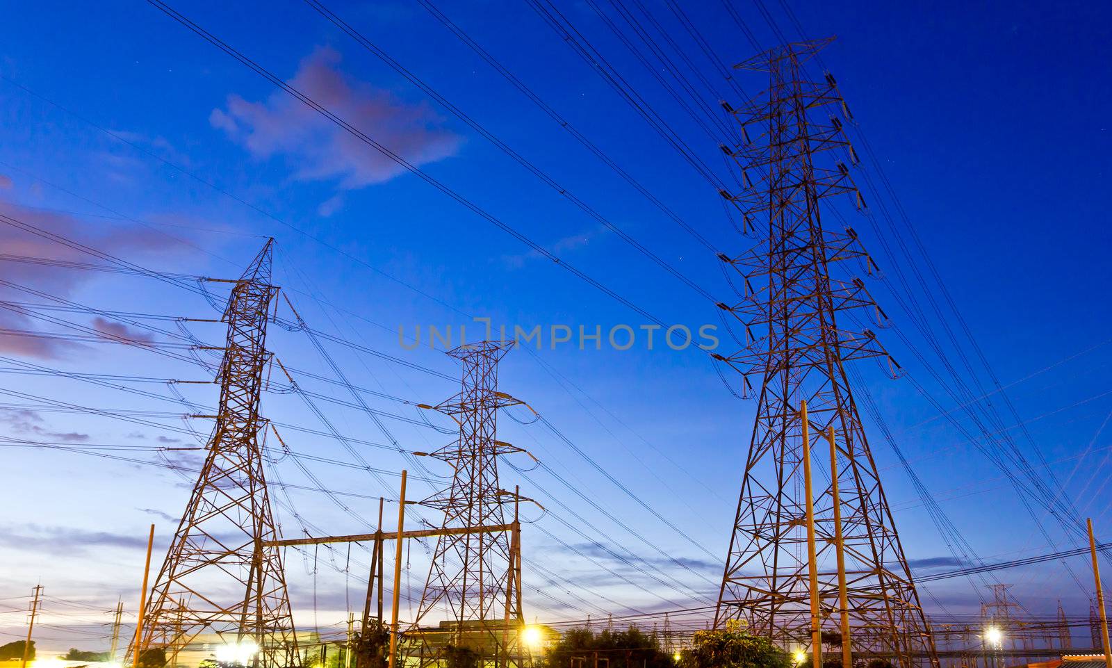 electric high voltage post in night sky by tungphoto