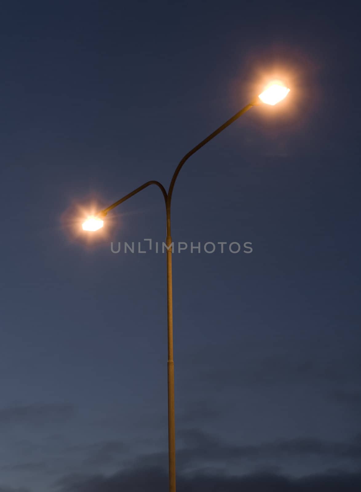 Streetlights in front of a dark blue sky