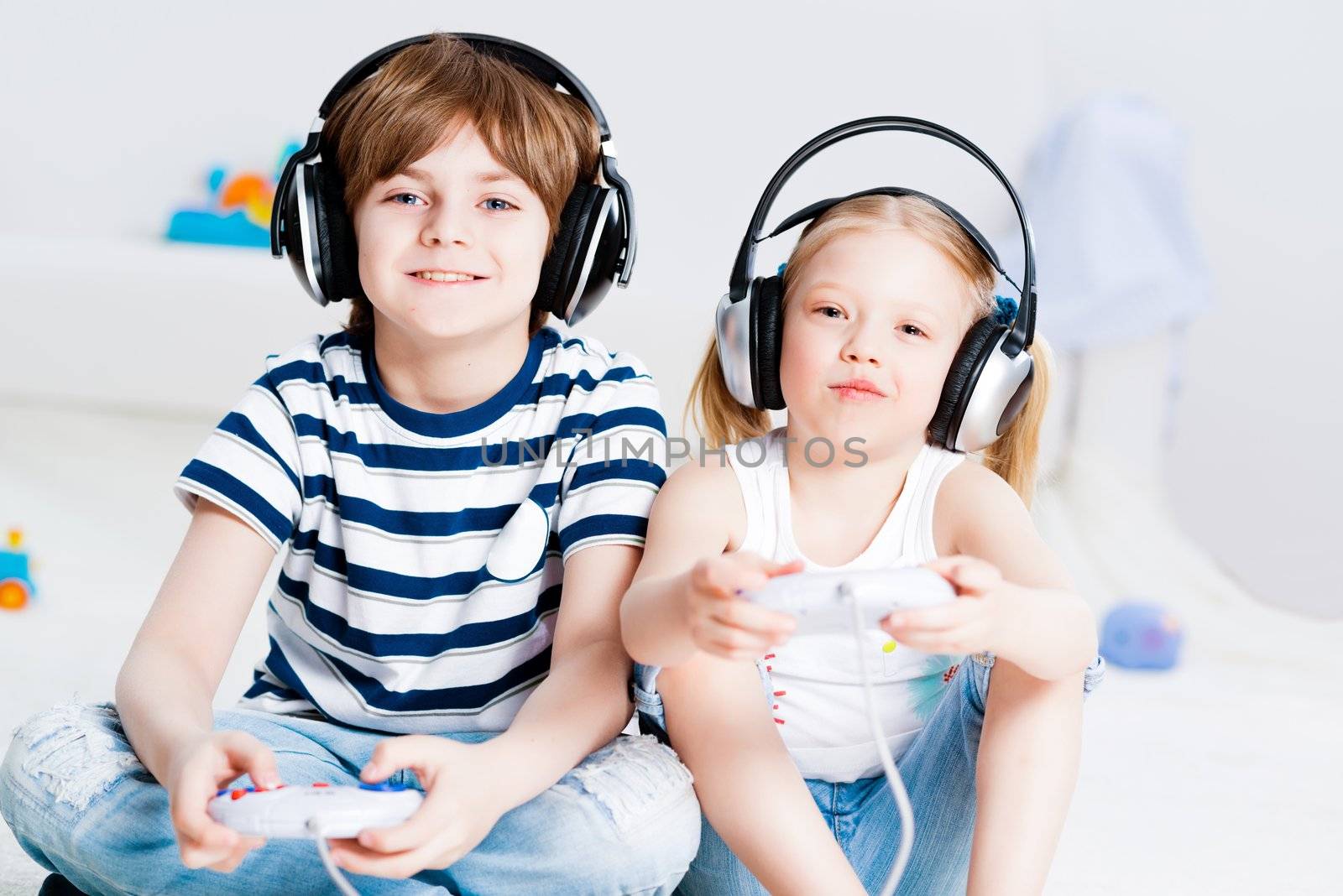cute boy and girl playing gaming console by adam121