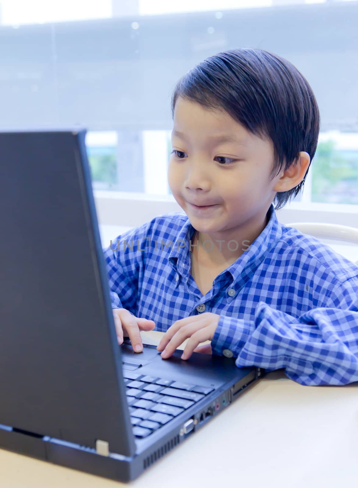 asian kid with laptop notebook by tungphoto