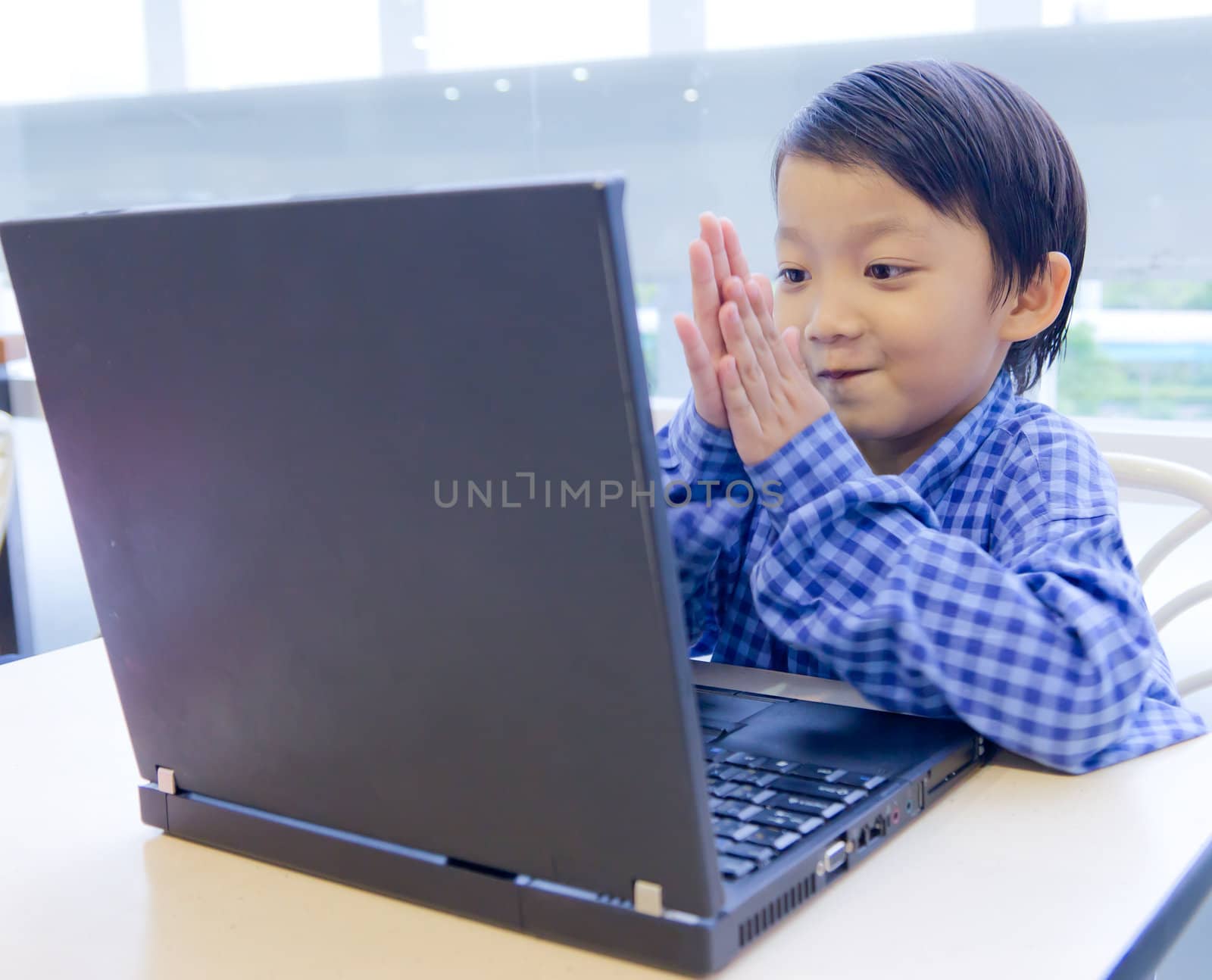 smile asian kid with laptop notebook by tungphoto