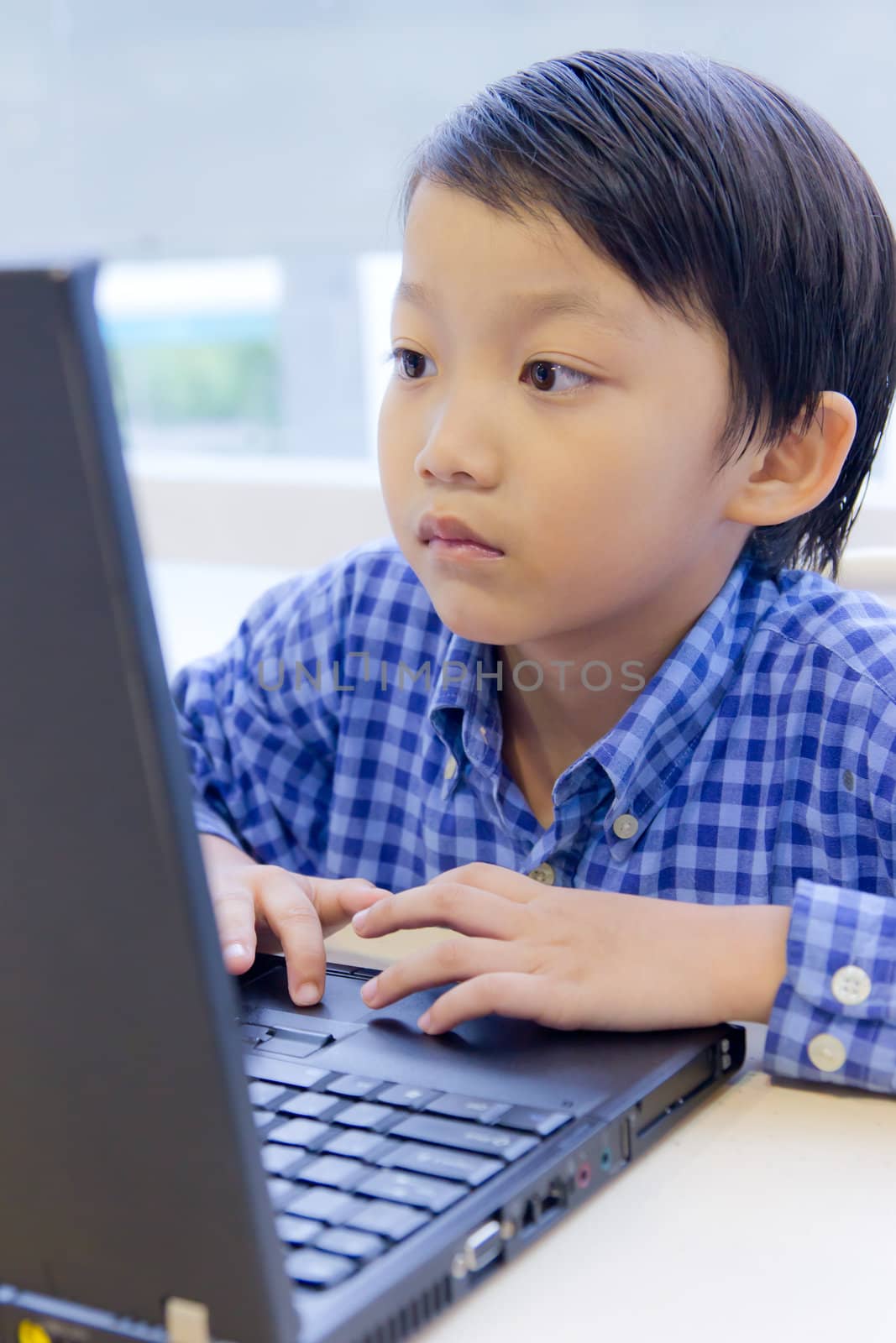 asian kid with laptop notebook by tungphoto