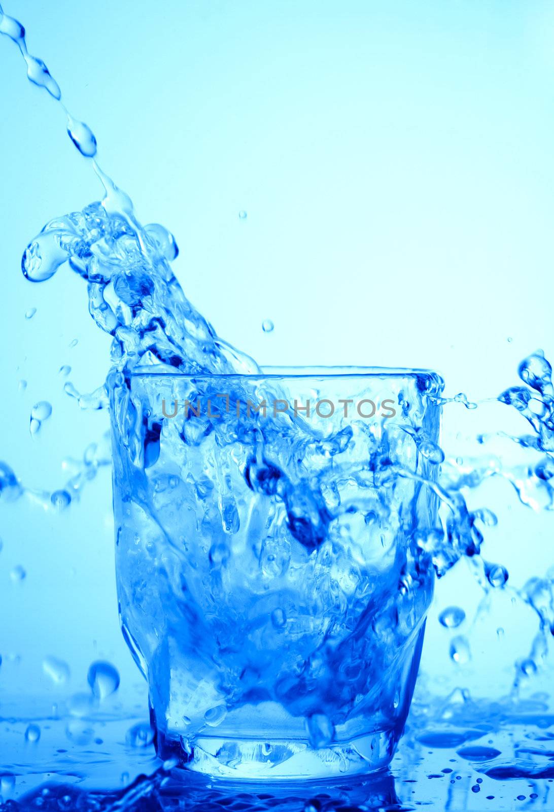 Drink theme: image of water splash in blue glass