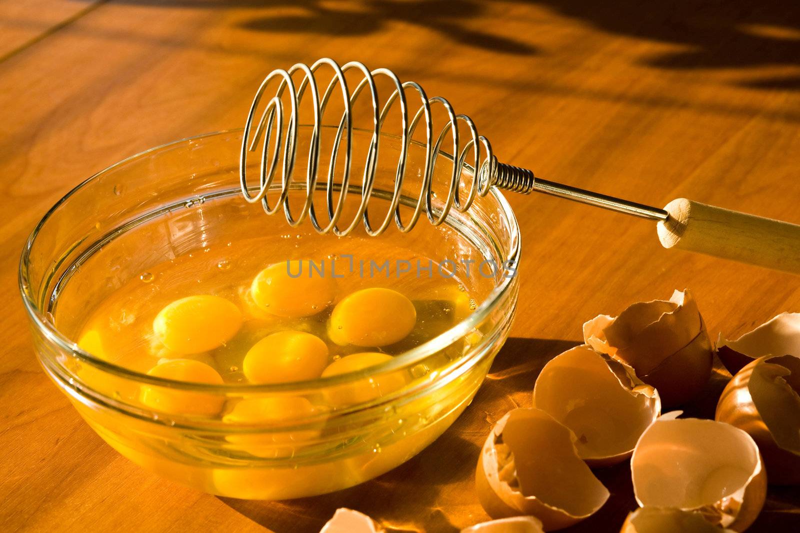 A glass plateful of eggs while an omelette preparing

