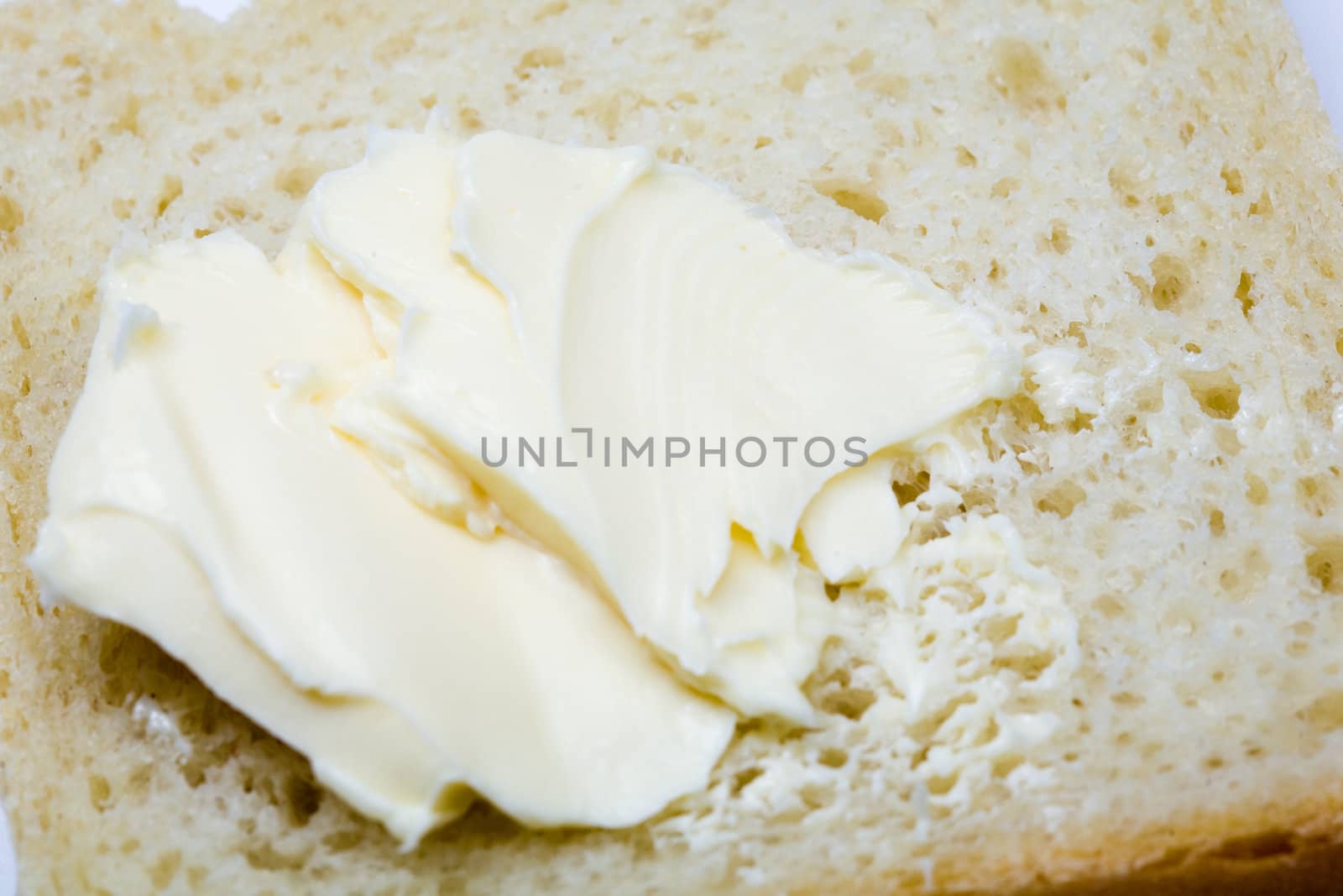 Stock photo: an image of yellow fresh butter on bread