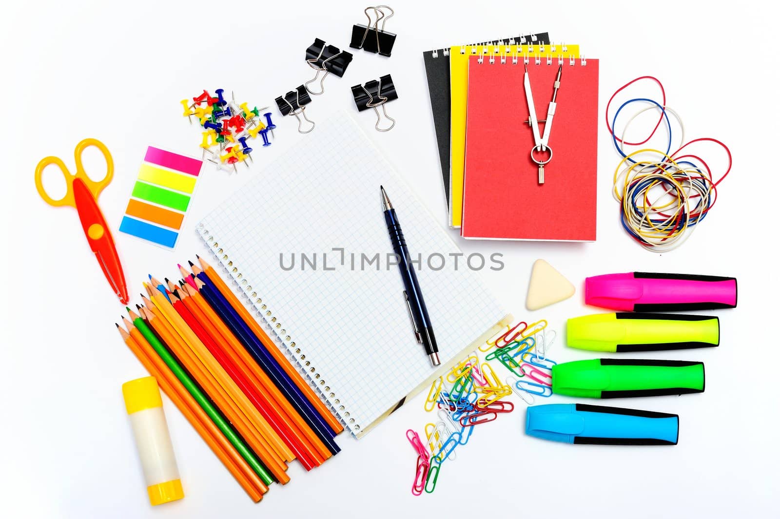 Notepad with stationary objects on white background