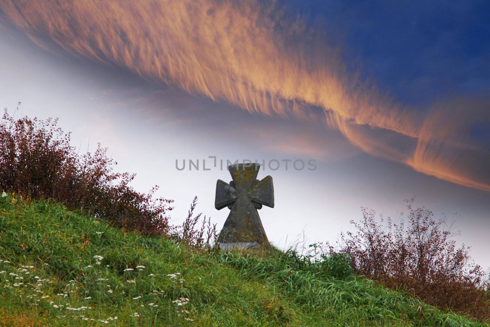 An image of old cross in a graveyard