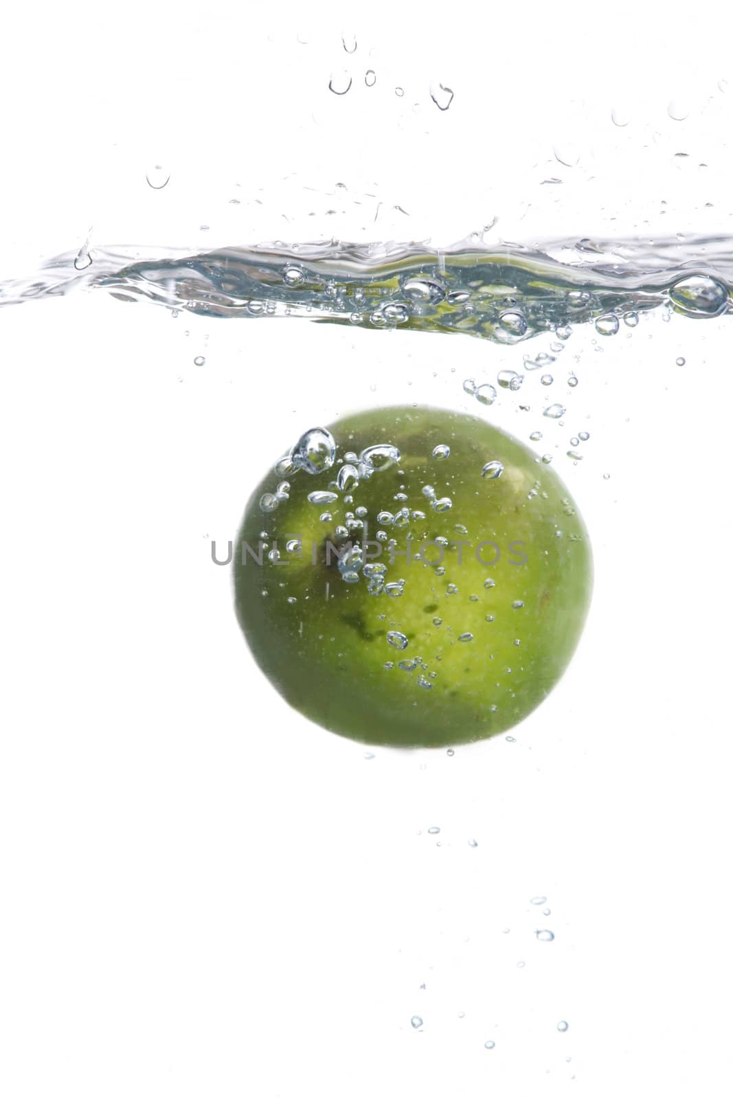 Green apple in water by velkol