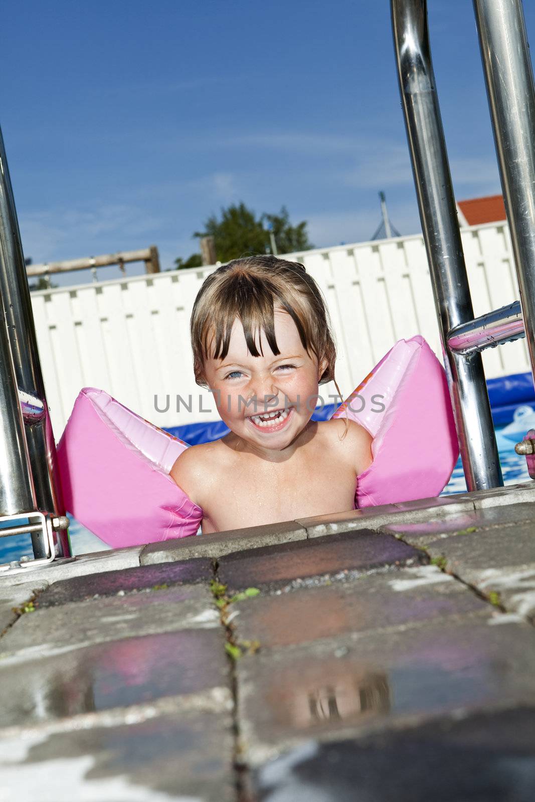 Young Happy Girl at the Swimming Pool
