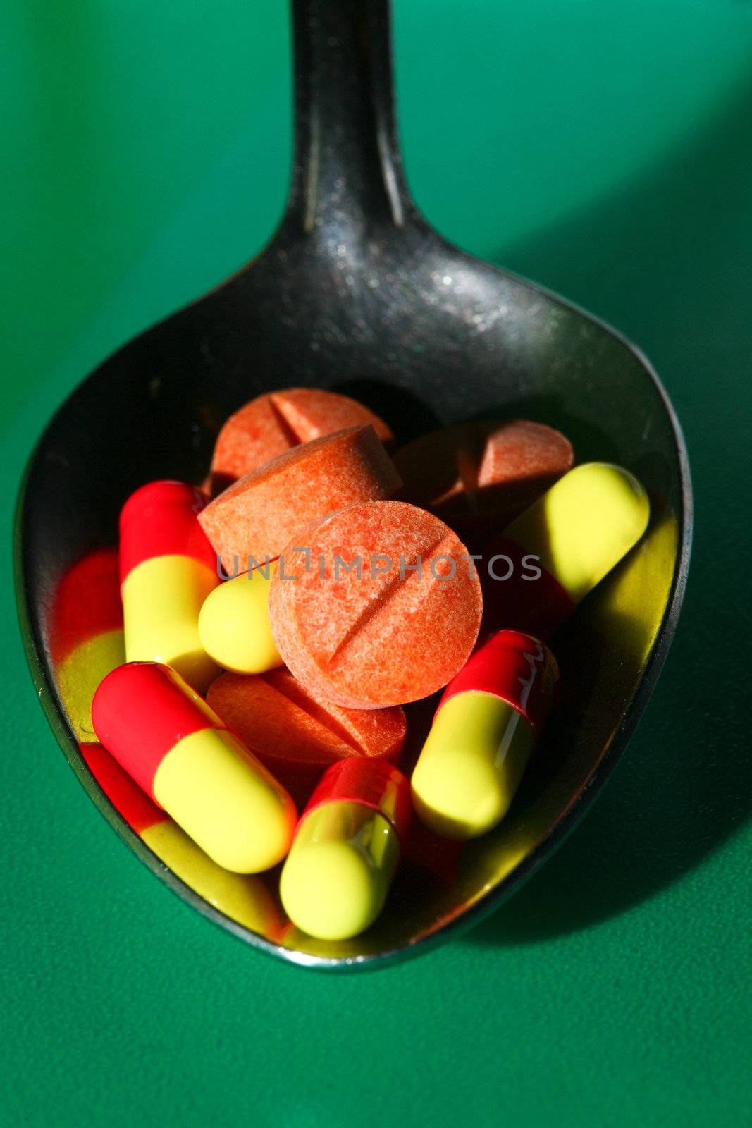 A stock of pills in iron spoon
