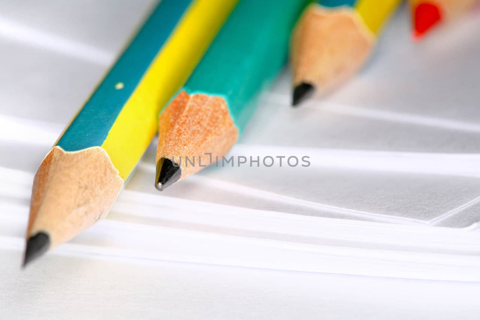 Closeup image of pencils laying on white paper