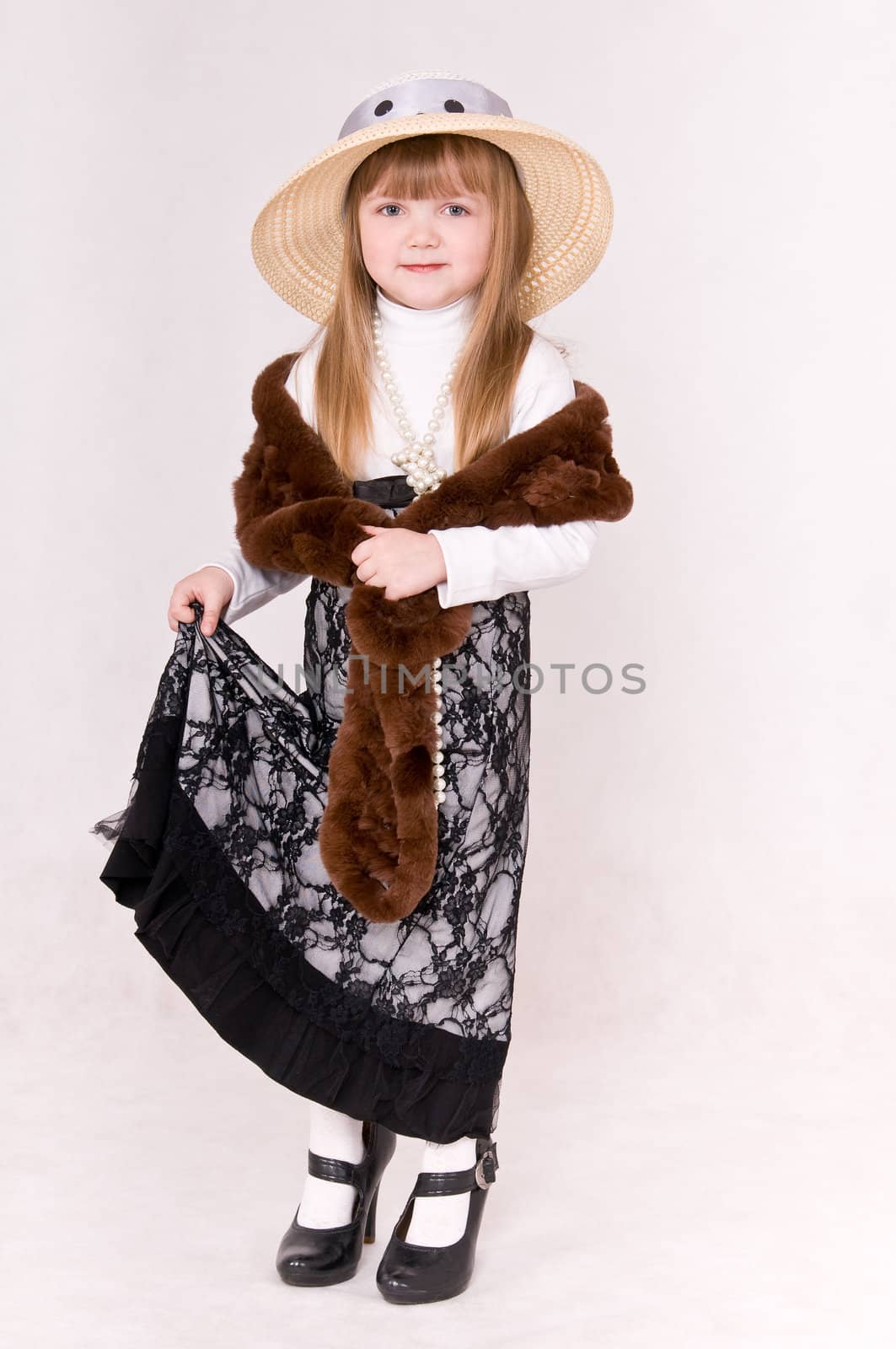 portrait little girl in long skirt and boa
