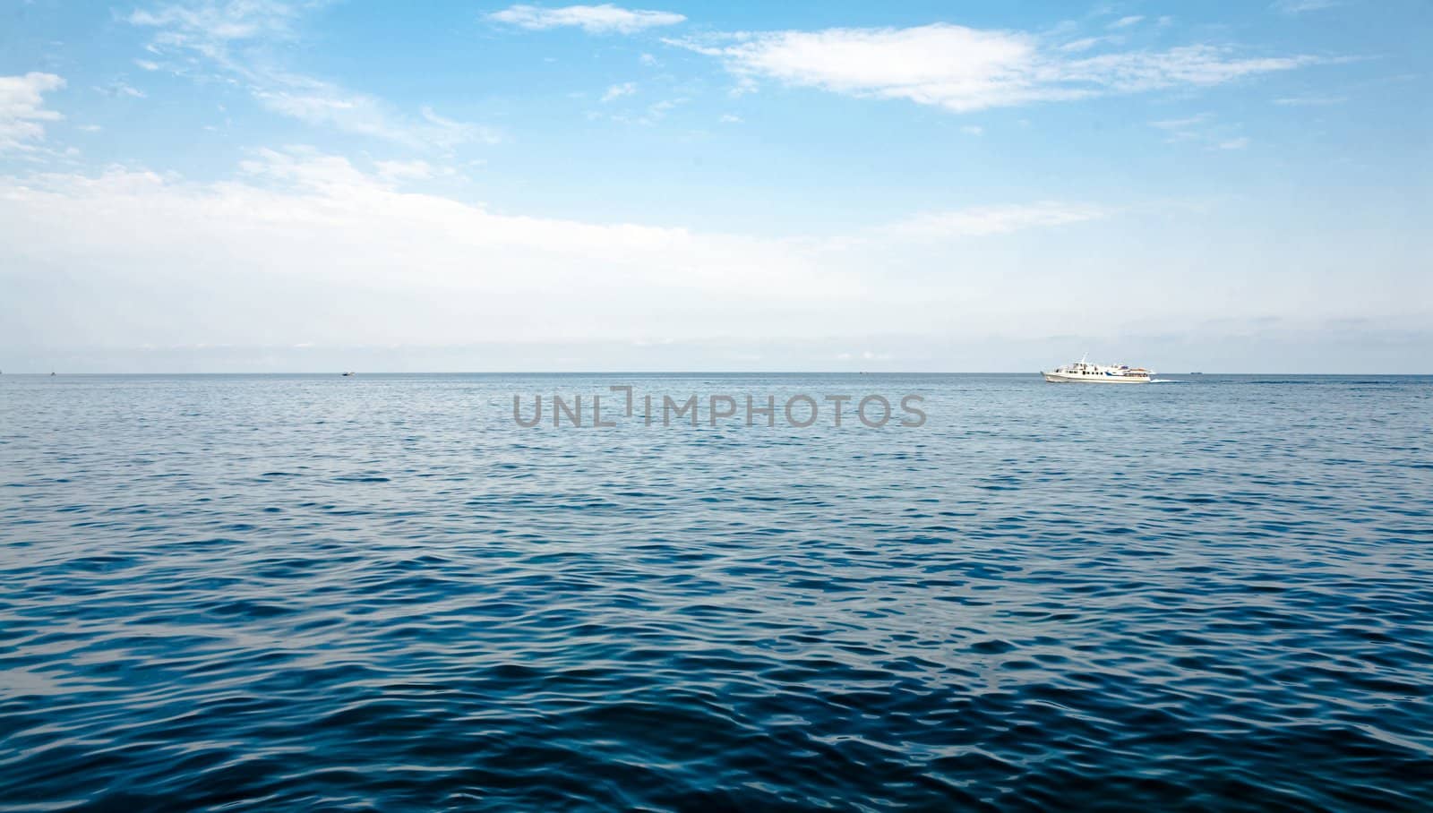 image blue water under the sky with clouds