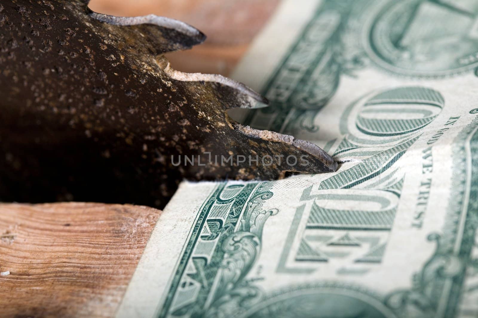 An image of a saw and one dollar