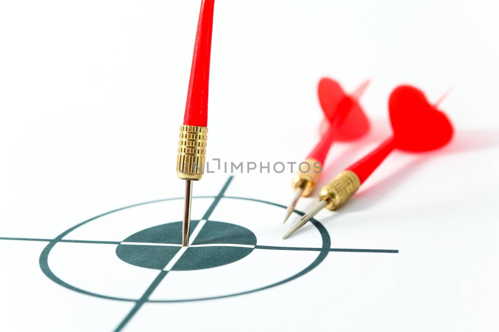 An image of tree darts and black target