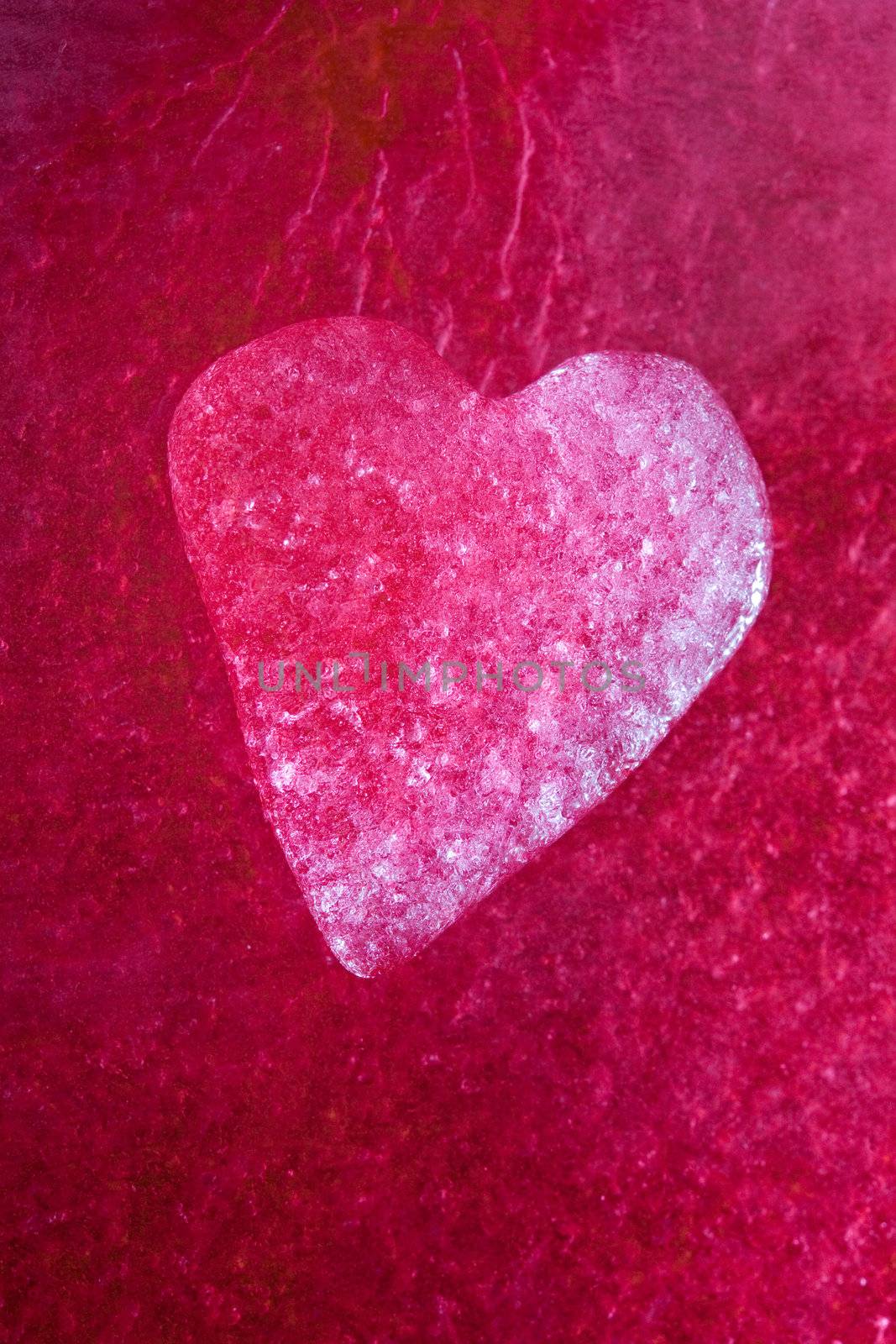 Stock photo: an image of an icy heart on a purple background