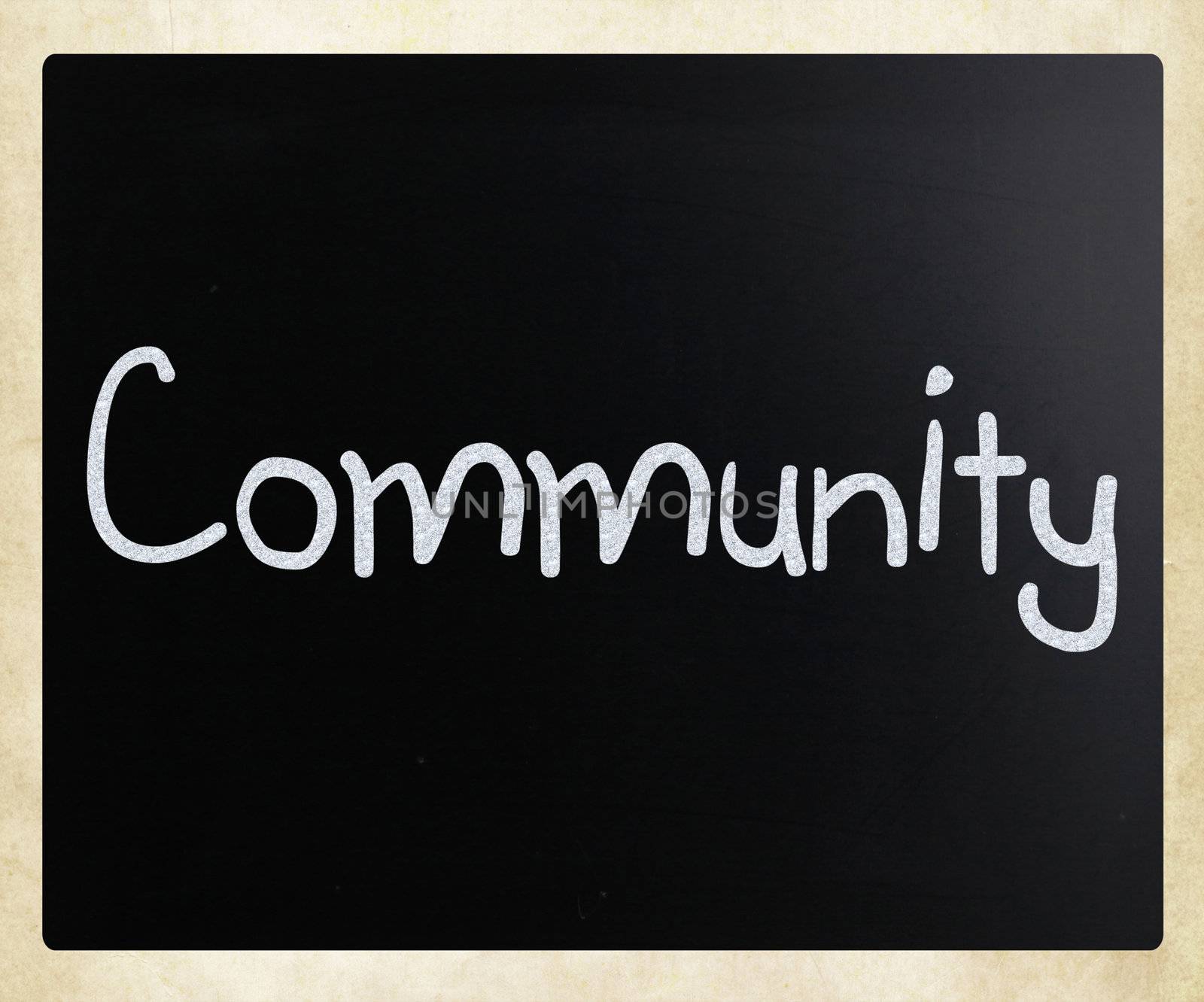 "Community" handwritten with white chalk on a blackboard by nenov