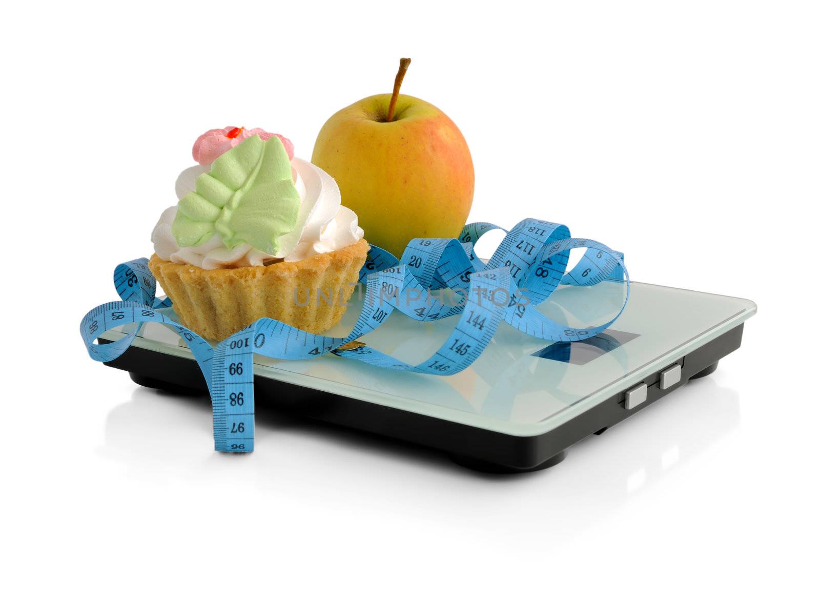 Cake and apple on scales measuring tape wrapped by Apolonia