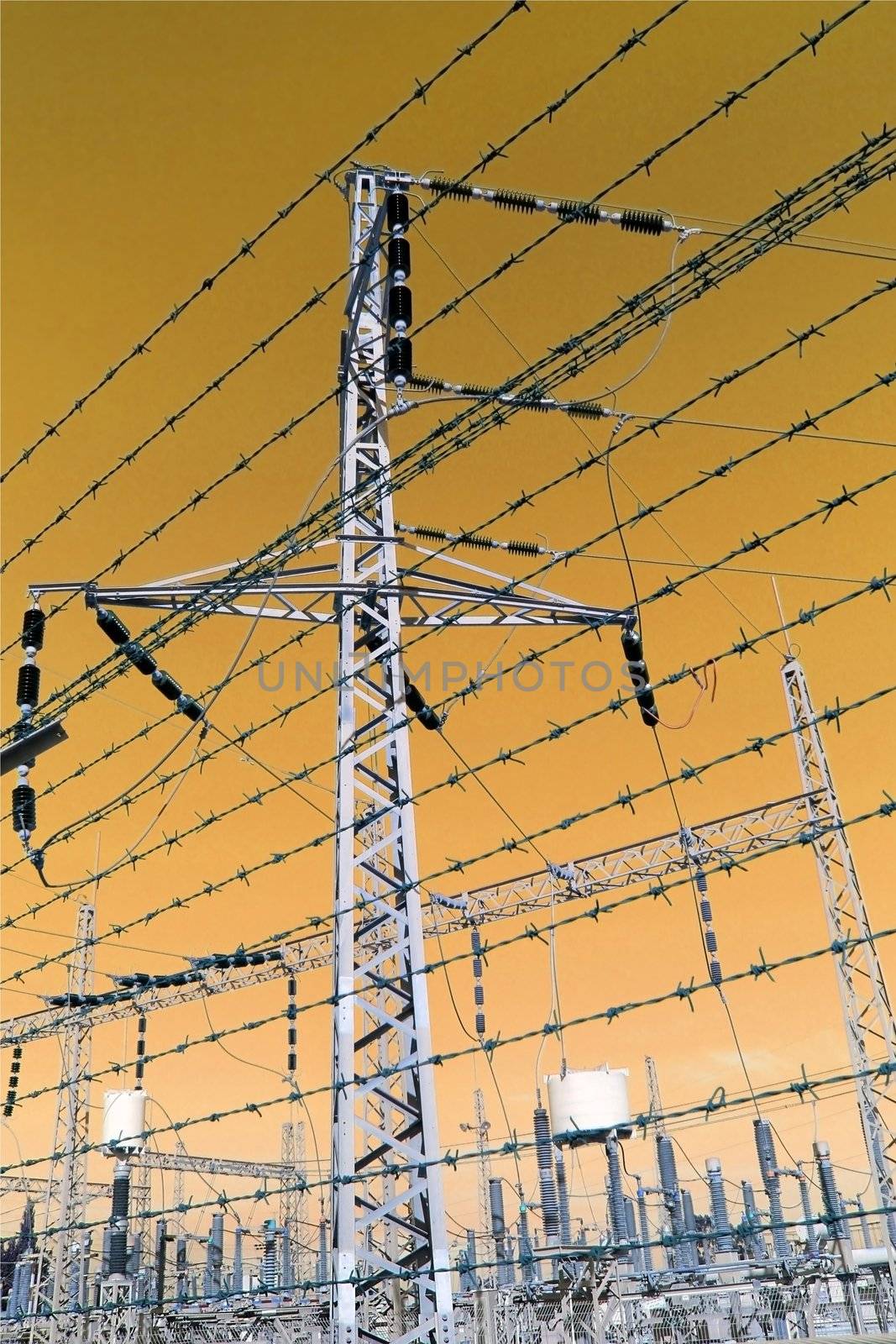 electricity substation behind a fence of barbed wire