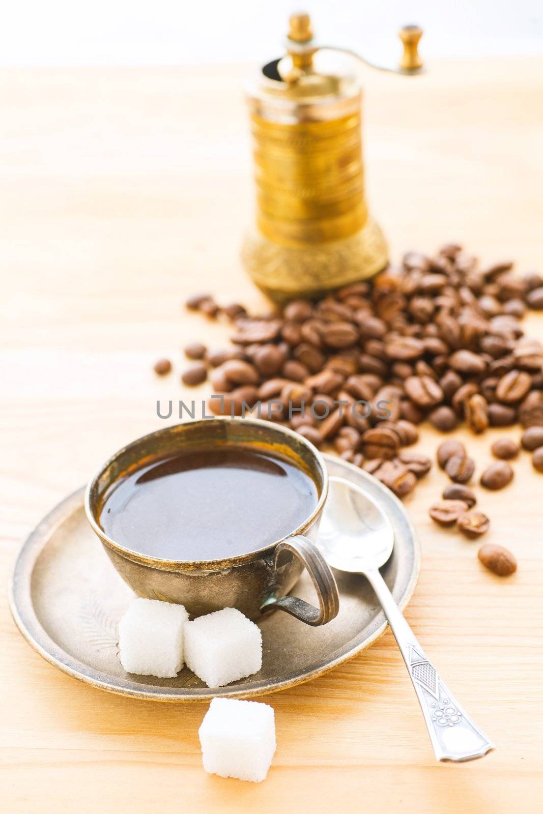 A cup of coffe with coffee bean as background. Vertical view