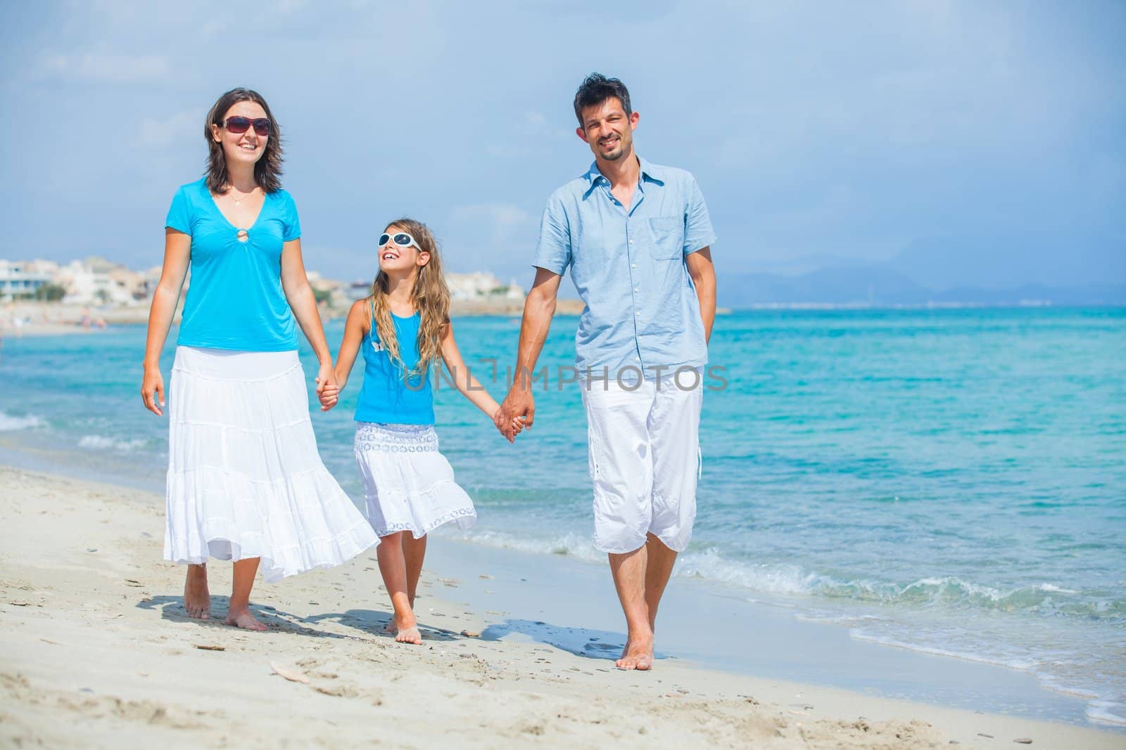 Family having fun on tropical beach by maxoliki