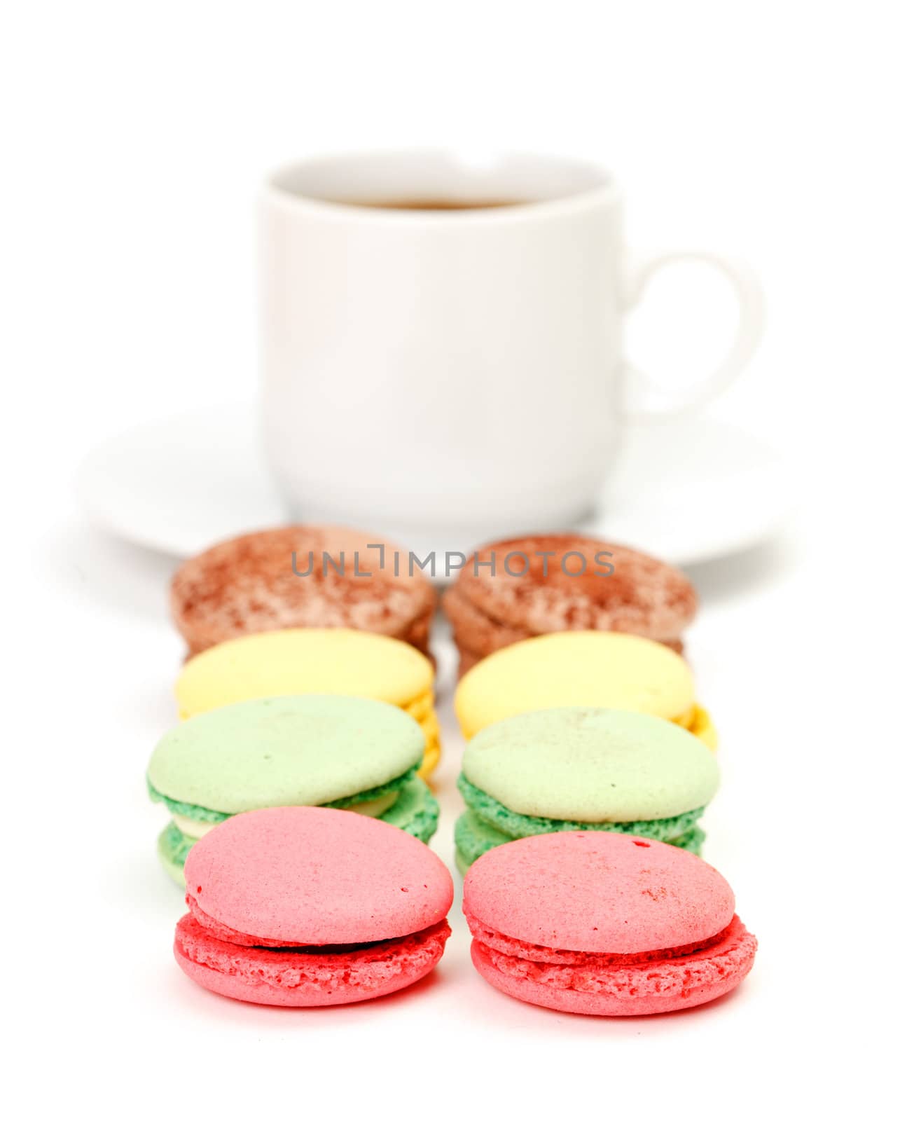 Colorful Macaroon and cup of coffee on white background