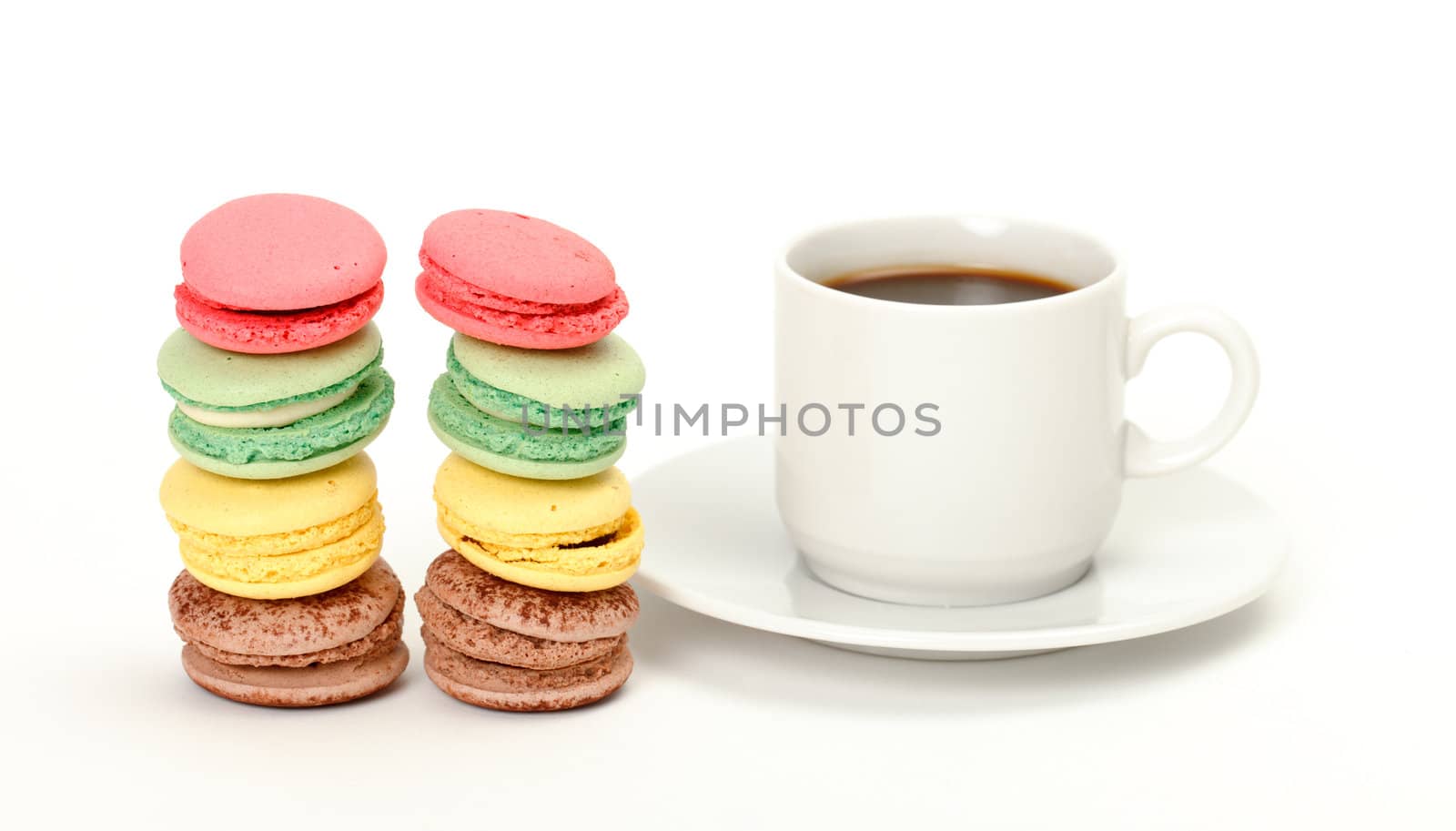 Colorful Macaroon and cup of coffee on white background