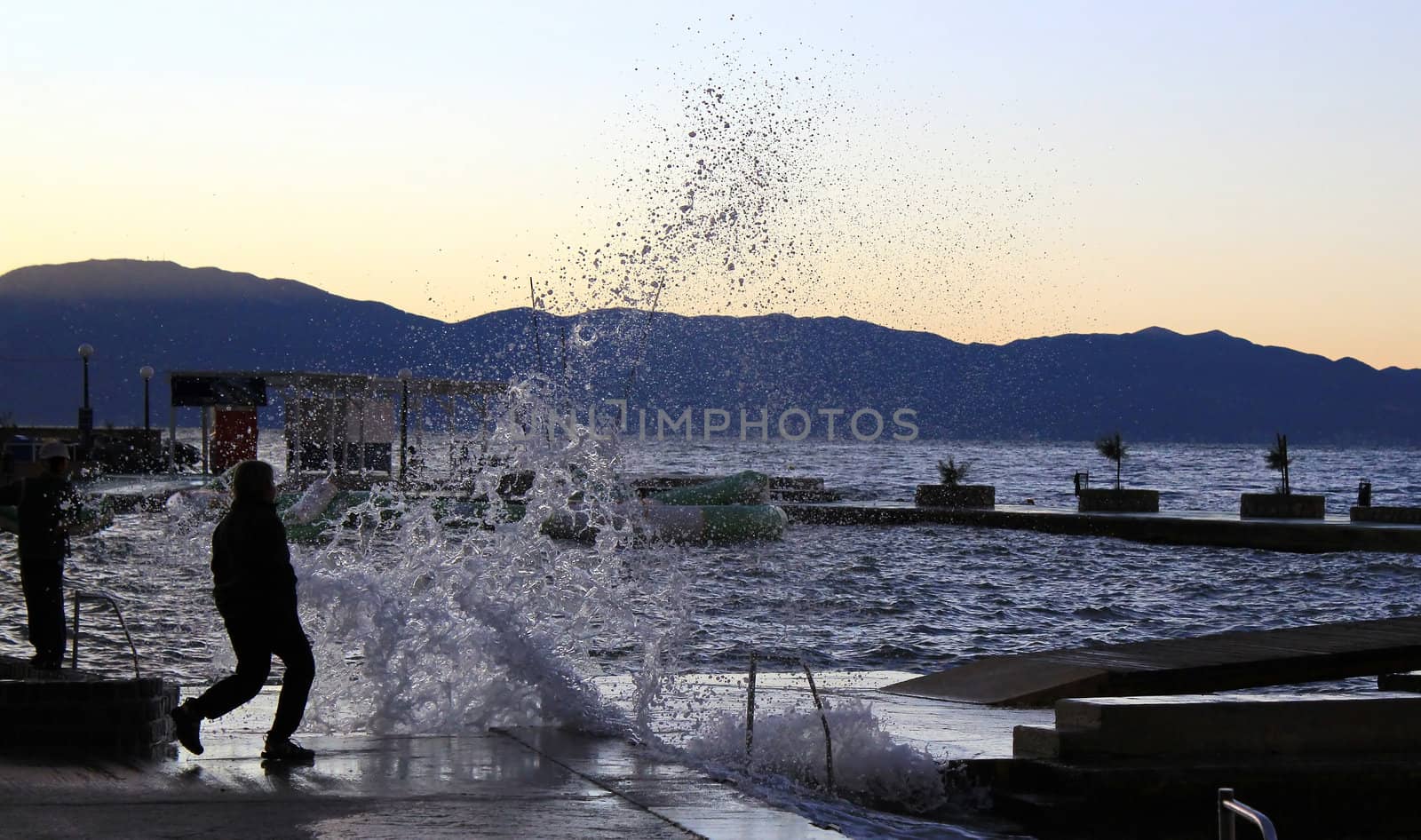 Ocean wave splash human silhouette, Krk, Croatia
