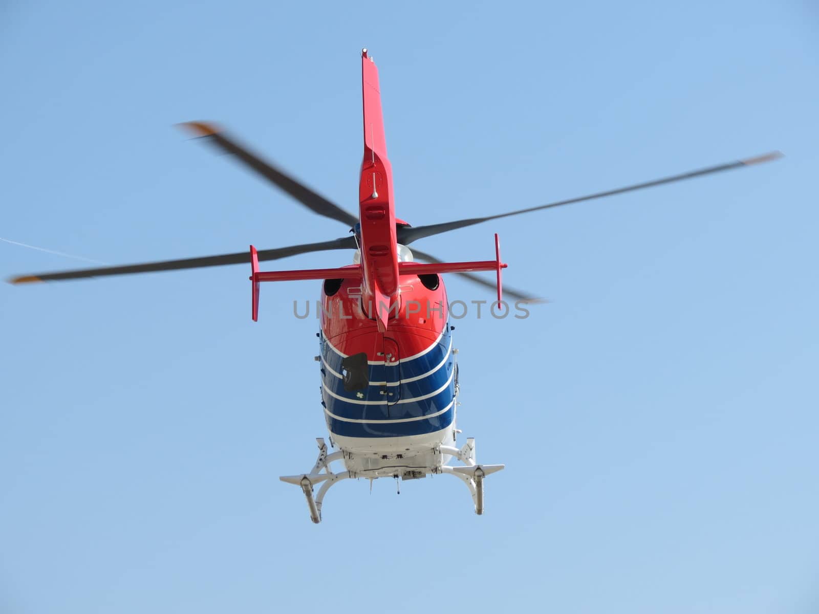 Helicopter flying high in the blue sky