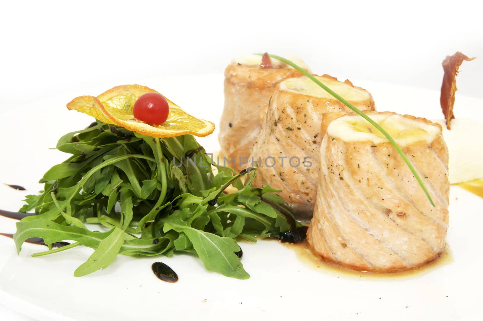 fried fish rolls with herbs and vegetables on white background