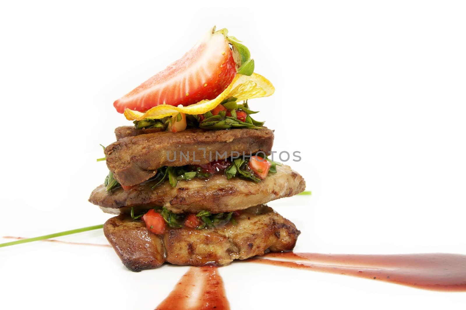 Fried goose liver with strawberries on a white background