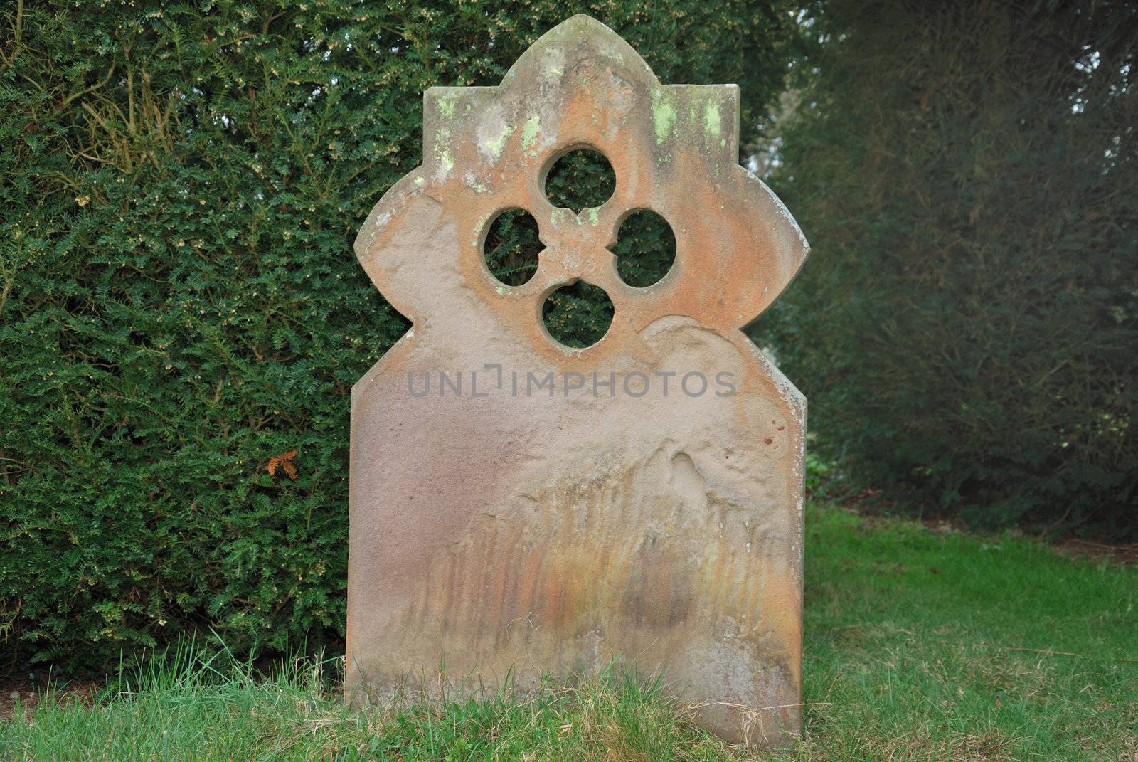 weathered grave stone in dark corner