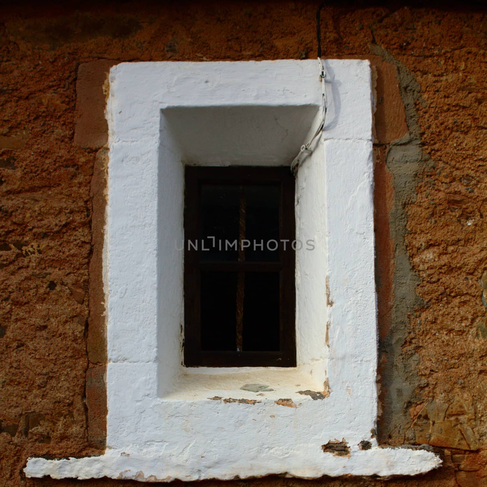 The window of an old church in the Spanish countryside.